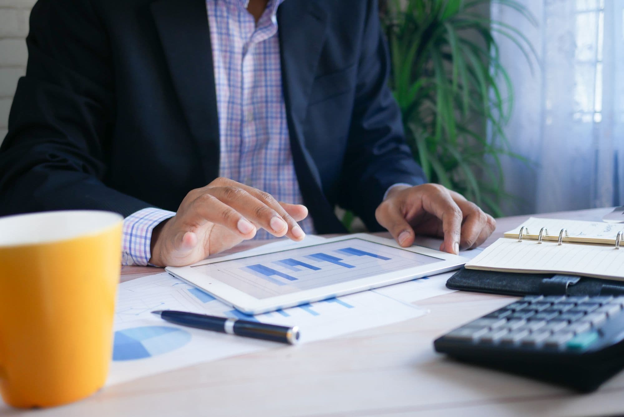 Man using a tablet to track his company spending